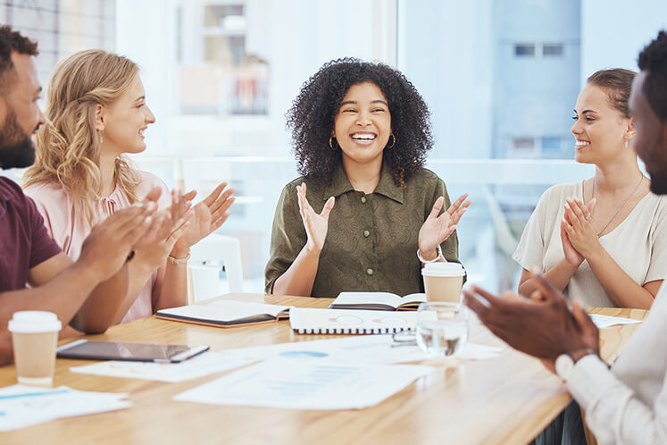 Colleagues sitting around a conference table in a modern office space